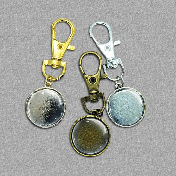 3 keyrings - bronze, sliver and gold colours on grey background